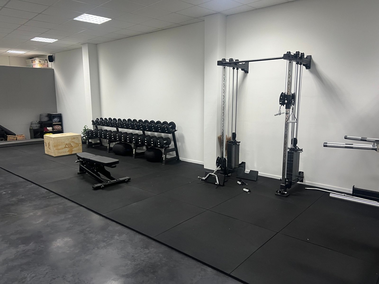 De vernieuwde fitnesszaal met gewichten en trainingsbank